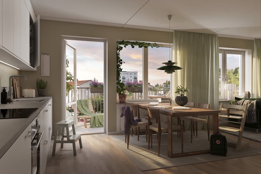 Ljust kök med matplats mot öppen balkongdörr.